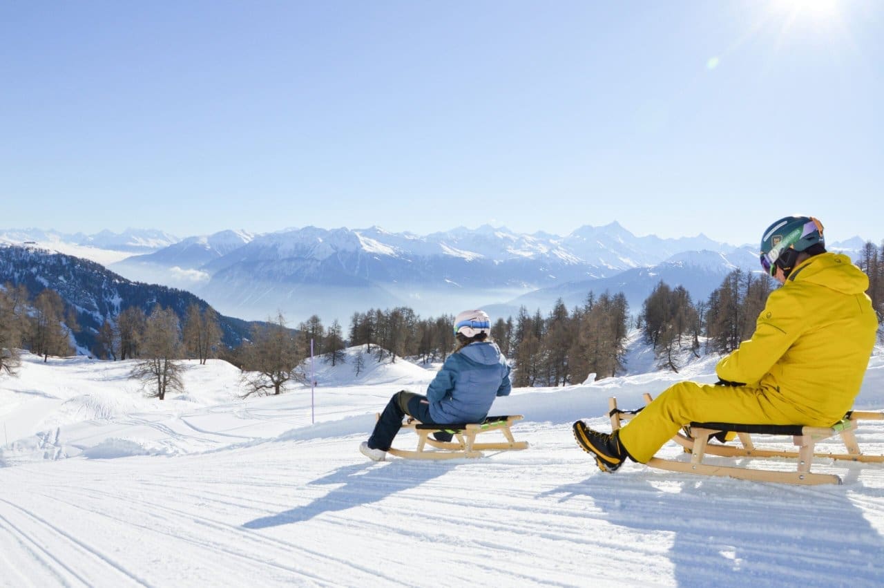 Family fun - sledging in Anzere, Switzerland’s premiere mountain resort. Credit Orane Jan du Chene