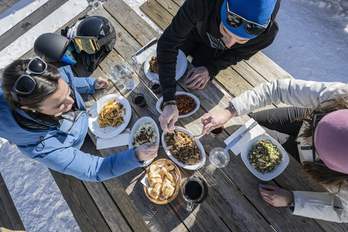 a birds-eye view of a picnic table laden with alpine food